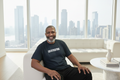 Man on modern luxury sofa with city view